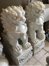A pair of Chinese guardian lion statues made of genuine white stone. picture