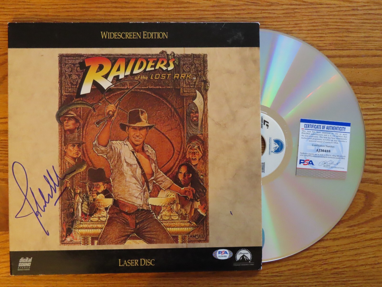 Conductor JOHN WILLIAMS signed RAIDERS OF THE LOST ARK 92 LaserDisc PSA AJ36488 Conductor JOHN WILLIAMS signed RAIDERS OF THE LOST ARK 92 LaserDisc PSA AJ36488